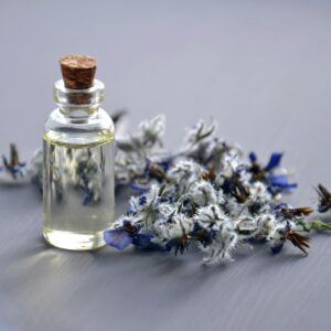 Close-up of a lavender oil bottle with dried flowers for aromatherapy. Perfect for wellness themes.